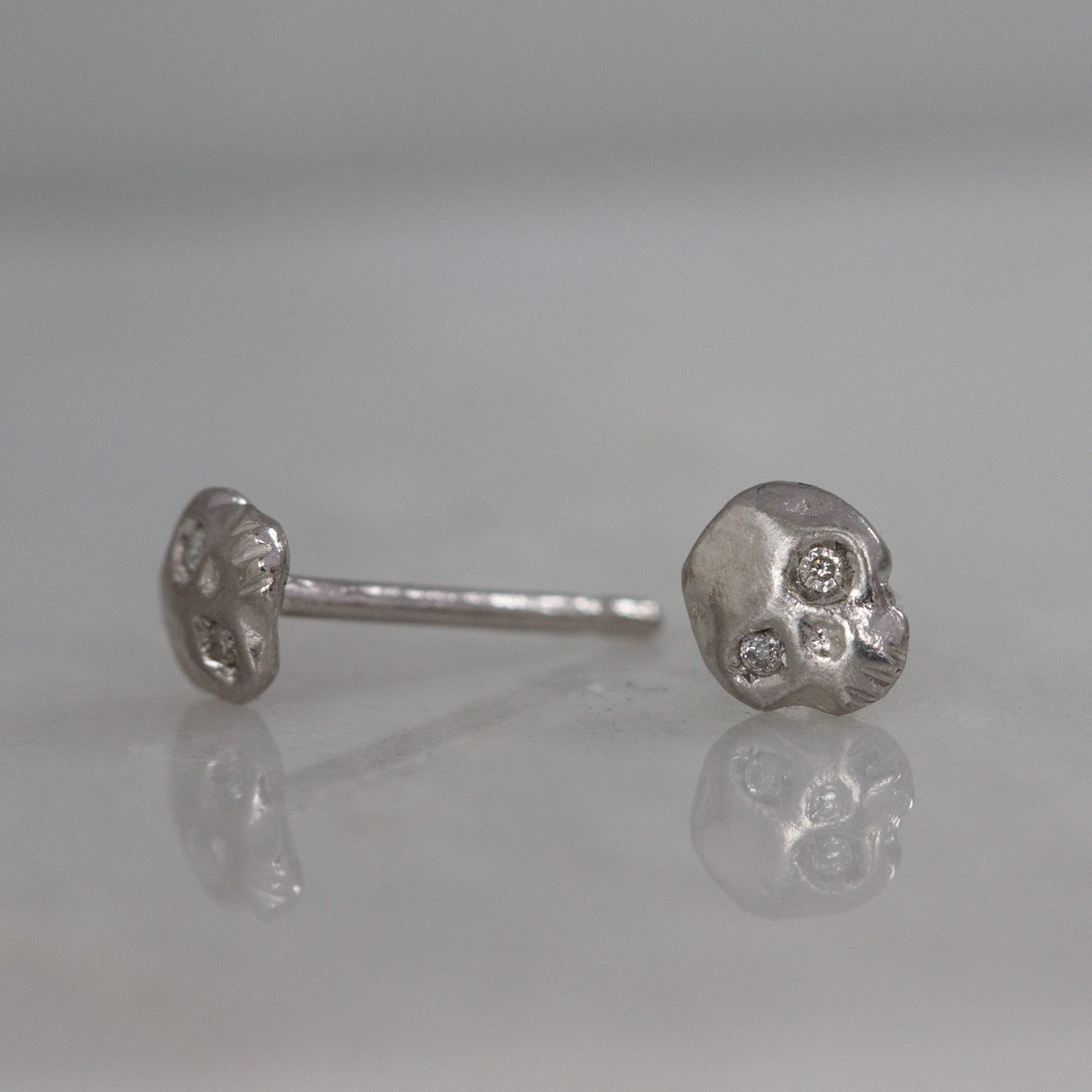 kelly star lannen, 12th house jewelry, ceremonial and celestial jewelry, sustainable jewelry, jewelry sculptor in NYC, handmade jewelry in NYC, Platinum Mignon skull studs with white diamond eyes, Celestial Jewelry, Anniversary jewelry, platinum earrings, boho bride